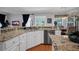 Open kitchen with stainless steel appliances, granite countertops, and a breakfast bar at 5913 Flatwoods Manor Cir, Lithia, FL 33547