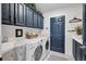 Well-organized laundry room with plenty of storage, modern washer and dryer, and lots of counter space at 5913 Flatwoods Manor Cir, Lithia, FL 33547