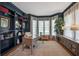 A dedicated office space features built-in bookshelves and large windows at 5913 Flatwoods Manor Cir, Lithia, FL 33547
