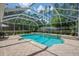 Screened-in pool area with water features and a spacious patio for entertaining and relaxation at 5913 Flatwoods Manor Cir, Lithia, FL 33547
