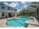 Inviting private screened-in pool features tile surround and integrated spa at 5913 Flatwoods Manor Cir, Lithia, FL 33547