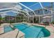 Backyard pool and spa with a screen enclosure, a patio, and a view of the home's exterior at 5913 Flatwoods Manor Cir, Lithia, FL 33547