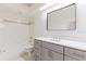 Bathroom featuring gray vanity, large mirror, and shower with tub at 6208 Country Club Way, Sarasota, FL 34243