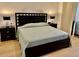 Queen bedroom with modern bed frame, matching end tables, and tiled flooring at 6208 Country Club Way, Sarasota, FL 34243