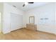 Light bedroom with wood floors, fan, closet, and dresser at 6208 Country Club Way, Sarasota, FL 34243