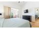 Bright bedroom with hard wood floors, flat screen tv, and access to the sunroom at 6208 Country Club Way, Sarasota, FL 34243