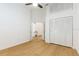 Bright bedroom featuring wood floors, fan, and spacious closet at 6208 Country Club Way, Sarasota, FL 34243