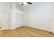 Bright bedroom featuring wood floors, fan, and large closet at 6208 Country Club Way, Sarasota, FL 34243
