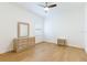 Light bedroom with wood floors, fan, and dresser at 6208 Country Club Way, Sarasota, FL 34243
