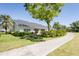 Home's exterior featuring lawn and walkway at 6208 Country Club Way, Sarasota, FL 34243