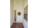 Welcoming front entrance with a decorative floral wreath on a white door and tiled flooring at 6208 Country Club Way, Sarasota, FL 34243