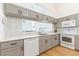 Modern kitchen featuring gray cabinets, white countertops, and stainless steel appliances at 6208 Country Club Way, Sarasota, FL 34243