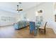 Open-concept living and dining area filled with natural light from shuttered windows and offering modern furnishings at 6208 Country Club Way, Sarasota, FL 34243