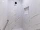 Elegant marble shower with rainfall shower head and tiled walls at 6208 Country Club Way, Sarasota, FL 34243