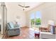 Relaxing sunroom featuring terracotta tile floor, ceiling fan, and sliding glass doors to private outdoor space at 6208 Country Club Way, Sarasota, FL 34243