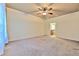 Bedroom featuring carpeted floors, ceiling fan and view of an ensuite bathroom at 6303 Hawk Grove Ct, Wesley Chapel, FL 33545
