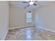 Neutral toned bedroom featuring tile floors and a ceiling fan at 6303 Hawk Grove Ct, Wesley Chapel, FL 33545
