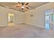 Spacious bedroom featuring a ceiling fan, neutral paint, and carpet flooring at 6303 Hawk Grove Ct, Wesley Chapel, FL 33545