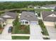 Charming home exterior with a well-manicured lawn, gray siding, and a two-car garage at 6303 Hawk Grove Ct, Wesley Chapel, FL 33545