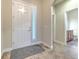 Bright foyer with tile flooring, white front door, and access to bathroom at 6303 Hawk Grove Ct, Wesley Chapel, FL 33545