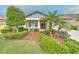 Charming single-story home featuring a well-manicured lawn and a red front door at 6303 Hawk Grove Ct, Wesley Chapel, FL 33545