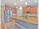 Kitchen island with stainless steel refrigerator, granite countertops, and pendant lighting at 6303 Hawk Grove Ct, Wesley Chapel, FL 33545
