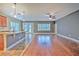 Open-concept living room with hardwood floors, natural light, and seamless flow to the kitchen and dining areas at 6303 Hawk Grove Ct, Wesley Chapel, FL 33545