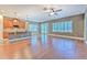Bright and spacious living room with hardwood floors, open to the kitchen and patio access at 6303 Hawk Grove Ct, Wesley Chapel, FL 33545