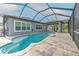 The screened-in pool has a spa, and a travertine deck, perfect for entertaining in this Florida home at 6303 Hawk Grove Ct, Wesley Chapel, FL 33545