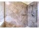 Detailed view of tiled shower with decorative accents and shower fixtures at 6303 Hawk Grove Ct, Wesley Chapel, FL 33545