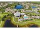 Aerial view highlighting the community buildings, pool, pier, lush landscaping, and lakes at 6518 Salt Creek Ave, Apollo Beach, FL 33572