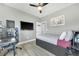 Bedroom featuring a ceiling fan, a cozy bed, a desk and chair for a productive workspace at 6518 Salt Creek Ave, Apollo Beach, FL 33572