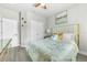 Bright bedroom featuring a ceiling fan, closet, and decorative accents for a cozy feel at 6518 Salt Creek Ave, Apollo Beach, FL 33572