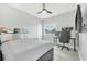 Bedroom featuring a ceiling fan, a cozy bed, a desk and chair for a productive workspace at 6518 Salt Creek Ave, Apollo Beach, FL 33572