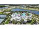 Aerial view showcases the community pool area with pools, clubhouse and palm trees at 6518 Salt Creek Ave, Apollo Beach, FL 33572