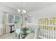 Elegant dining area with a glass-top table and stylish chairs near a bright window at 6518 Salt Creek Ave, Apollo Beach, FL 33572