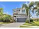 Charming two-story home with stone accents, a well-maintained lawn, and a convenient two-car garage at 6518 Salt Creek Ave, Apollo Beach, FL 33572