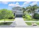 Charming two-story home with stone accents, a well-maintained lawn, and a convenient two-car garage at 6518 Salt Creek Ave, Apollo Beach, FL 33572