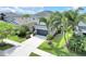 Well-manicured lawn with a charming two-story home with stone accents, an attached two-car garage at 6518 Salt Creek Ave, Apollo Beach, FL 33572