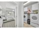 Convenient laundry room and bedroom with ample storage space and modern appliances at 6518 Salt Creek Ave, Apollo Beach, FL 33572