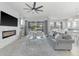 Bright, airy living room showcasing contemporary design, fireplace feature, and access to outdoor patio and entertainment at 6518 Salt Creek Ave, Apollo Beach, FL 33572