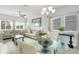 Sun-filled living room and dining area showcase neutral tones and updated flooring at 6518 Salt Creek Ave, Apollo Beach, FL 33572