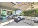 Inviting outdoor patio features a dining area, grill, and cozy seating area with a fire pit at 6518 Salt Creek Ave, Apollo Beach, FL 33572