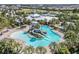 Stunning resort-style pool featuring a waterslide and plenty of lounge chairs surrounded by lush landscaping and palm trees at 6518 Salt Creek Ave, Apollo Beach, FL 33572