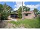 Landscaped backyard features a screened-in lanai and well-maintained lawn at 7020 Oakview Cir, Tampa, FL 33634