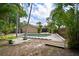 Backyard pool area featuring lush tropical landscaping, concrete pool deck and a wood walkway at 7020 Oakview Cir, Tampa, FL 33634