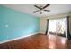 Bright bedroom features wood floors, sliding glass doors to the courtyard, and a ceiling fan at 7020 Oakview Cir, Tampa, FL 33634