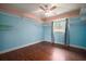 Light-filled bedroom with wood-look floors, decorative trim, and shelving for personal touches at 7020 Oakview Cir, Tampa, FL 33634