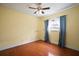 Comfortable bedroom featuring a ceiling fan, wood-look floors, and a window with natural light at 7020 Oakview Cir, Tampa, FL 33634