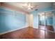 Cozy bedroom with wood-look floors, shelving, and mirrored closet doors for extra space and light at 7020 Oakview Cir, Tampa, FL 33634